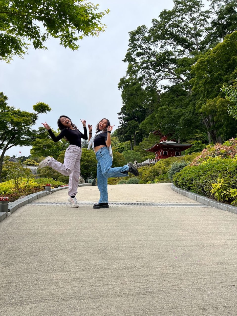 Bestie jump photo with the temple pagoda in the background